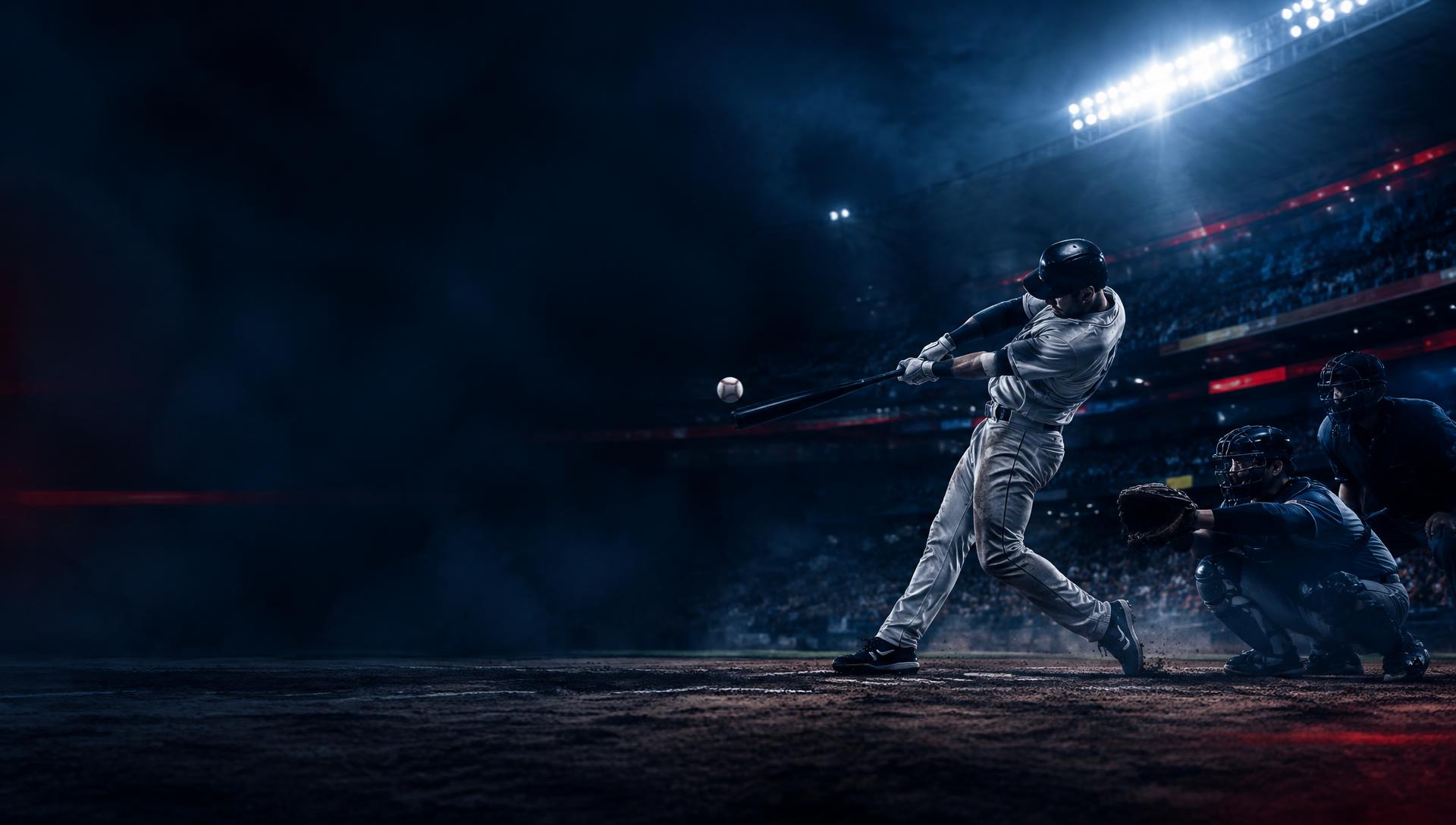 Baseball player connecting with a pitch under stadium lights